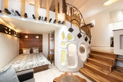a room with a bed and a stair case at Krakowhomes in Kraków