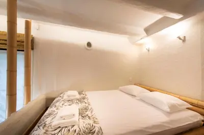 a bedroom with a bed with two white pillows at Krakowhomes in Kraków