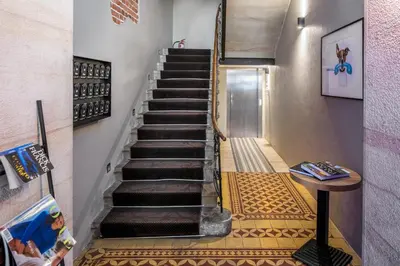 a staircase with a tiled floor in a house at Aparthotel Pergamin in Kraków