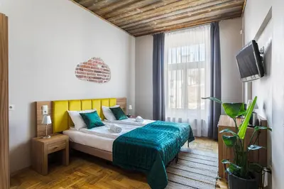 a bedroom with a bed and a tv in it at Aparthotel Pergamin in Kraków