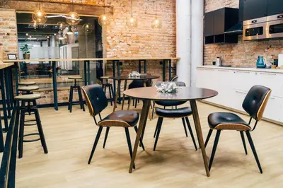 two glasses of wine and a cup on a table at Wine Apartments in Kraków