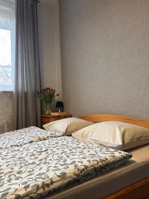 a bedroom with two beds and a window at Bronowice in Kraków