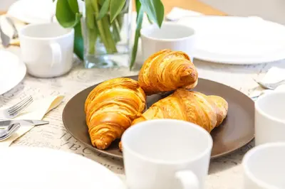 two croissants on a plate on a table at Bronowice in Kraków