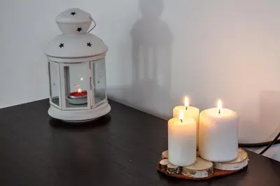 two candles and a lantern on a table at Bronowice in Kraków