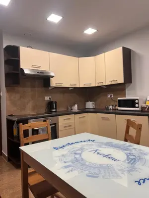 a kitchen with a table and a counter top at Bronowice in Kraków