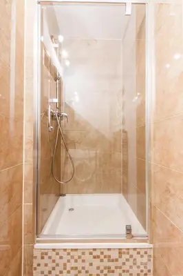 a shower with a glass door in a bathroom at Bronowice in Kraków