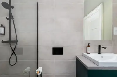 a bathroom with a sink and a shower at 1898 Parkside Boutique Residence in Kraków
