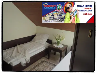 a picture of a small room with a bed and a magazine at Willa Zacisze - Apartament dwupoziomowy in Kalwaria Zebrzydowska