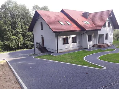 a house with a red roof on a road at Willa Zacisze - Apartament dwupoziomowy in Kalwaria Zebrzydowska
