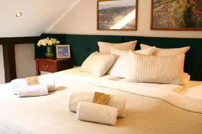 a large white bed with two pillows on it at Miodosytnia Aparthotel in Kraków