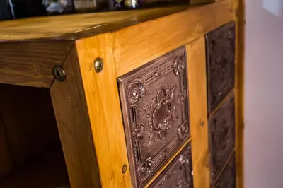 an antique wooden cabinet with a wooden door at Lovenovsky Apartments in Kraków