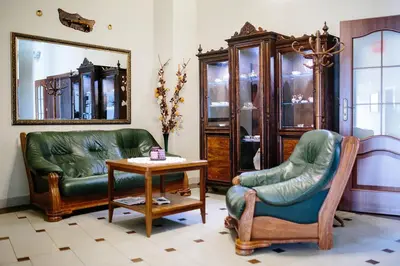 a living room with two chairs and a table at Pałac Koronny Noclegi & Wypoczynek in Wodzisław
