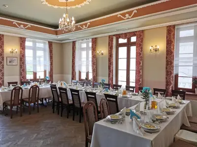 a conference room with tables and chairs and windows at Pałac Koronny Noclegi & Wypoczynek in Wodzisław