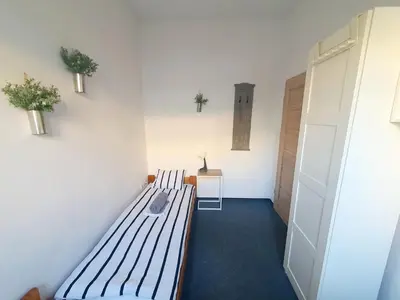a room with a bench in a room with a door at Master Corner Apartment in Kraków