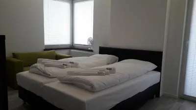 a bed in a room with three pillows on it at BAKO Apartments in Skawina
