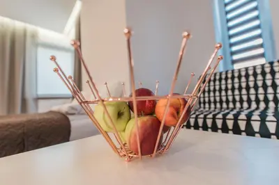 a basket of apples sitting on a table at BAKO Apartments in Skawina