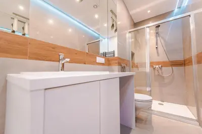a bathroom with a white sink and a toilet at BAKO Apartments in Skawina