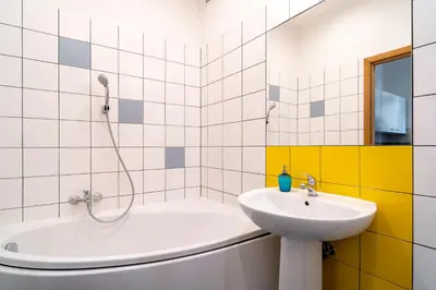 a bathroom with a tub and a sink and a shower at Kazimierz Pearl Apartments in Kraków