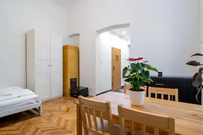 a dining room with a table and a potted plant at Kazimierz Pearl Apartments in Kraków