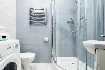 a bathroom with a shower and a toilet and a sink at PlayHouse Apartments in Kraków