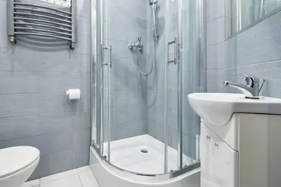 a bathroom with a shower and a sink and a toilet at PlayHouse Apartments in Kraków