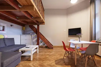a living room with a couch and a table at PlayHouse Apartments in Kraków