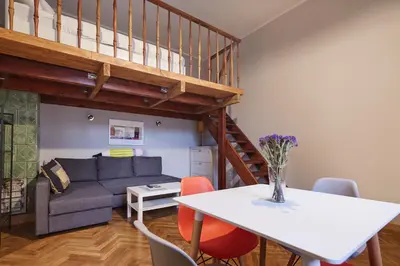 a living room with a couch and a table at PlayHouse Apartments in Kraków