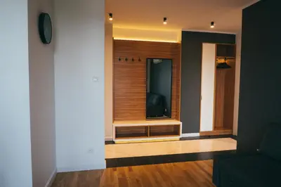 a living room with a window and a television at Grey Apartment Kołowa in Kraków