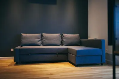 a blue couch sitting in a room at Grey Apartment Kołowa in Kraków