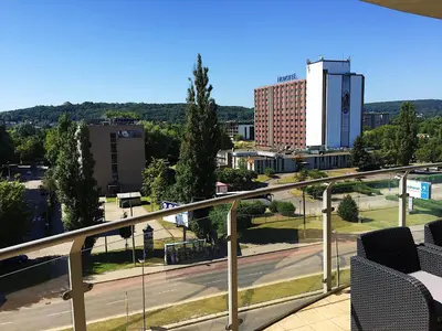 a view of a city from the balcony of a building at Grey Apartment Kołowa in Kraków