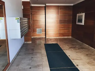 a room with wooden walls and a hallway with a rug at Grey Apartment Kołowa in Kraków