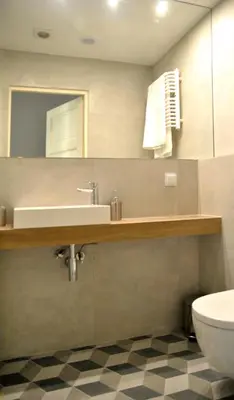 a bathroom with a sink and a toilet at Florianska Apartment in Kraków