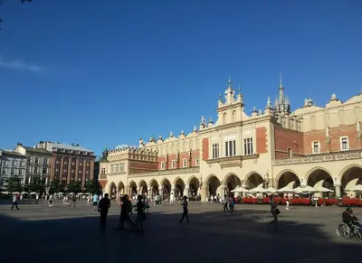 a large building with people walking in front of it at Florianska Apartment in Kraków