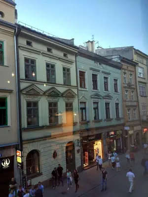 a group of people walking in front of a building at Florianska Apartment in Kraków