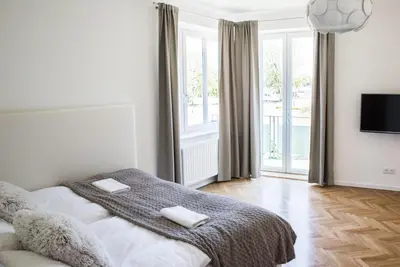 a bedroom with a bed with two towels on it at Apartment Nearto Old Town Na Ustroniu street in Kraków