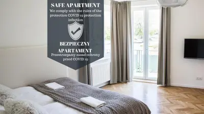 a bedroom with a bed with a sign on the wall at Apartment Nearto Old Town Na Ustroniu street in Kraków