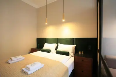 a bedroom with a bed with two towels on it at FAUST Apartments in the Heart of KAZIMIERZ by MINT APARTMENT in Kraków