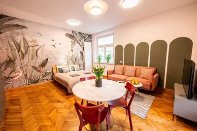 a living room with a table and a couch at Trip Apartments in Kraków