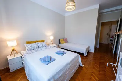 a bedroom with two beds and a window at Trip Apartments in Kraków