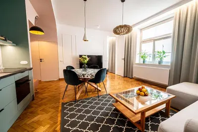 a living room with a couch and a table at Trip Apartments in Kraków