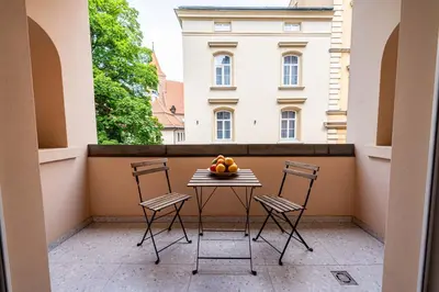 a dining room with a table and a large window at Trip Apartments in Kraków