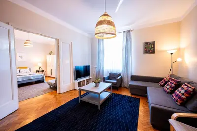 a kitchen with blue cabinets and a large window at Trip Apartments in Kraków