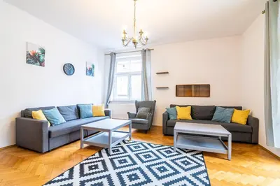 a living room with a table with a plant on it at Trip Apartments in Kraków