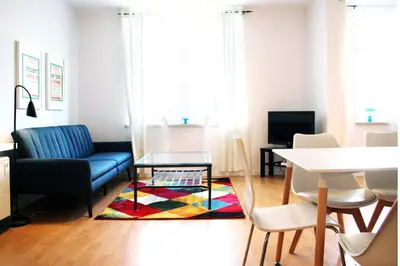 a living room with a couch and a table at Mona Lisa Apartments - Kazimierz District in Kraków