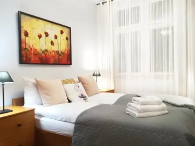 a bedroom with a bed and a painting on the wall at Mona Lisa Apartments - Kazimierz District in Kraków