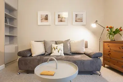 a living room with a couch and a coffee table at Mona Lisa Apartments - Kazimierz District in Kraków