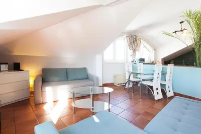 a living room with a table and a couch at Mona Lisa Apartments - Kazimierz District in Kraków