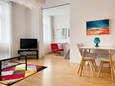 a living room with a table and a dining room at Mona Lisa Apartments - Kazimierz District in Kraków