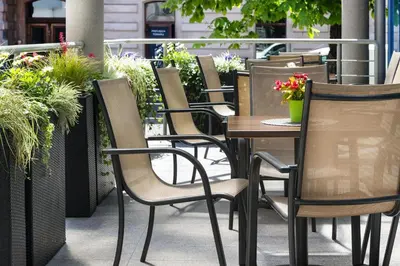 a row of chairs and tables on a patio at Best Western Plus Krakow Old Town in Kraków