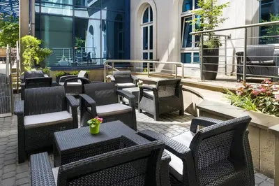 a group of chairs and tables on a patio at Best Western Plus Krakow Old Town in Kraków